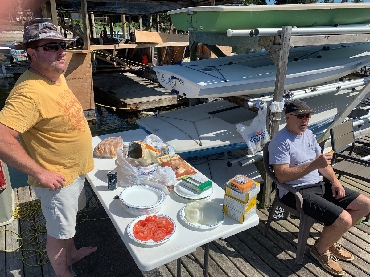 Ken Olson get the fixing ready to go as Dennis Olson speaks about the wind conditions at the 2019 Poise Cove Regatta.