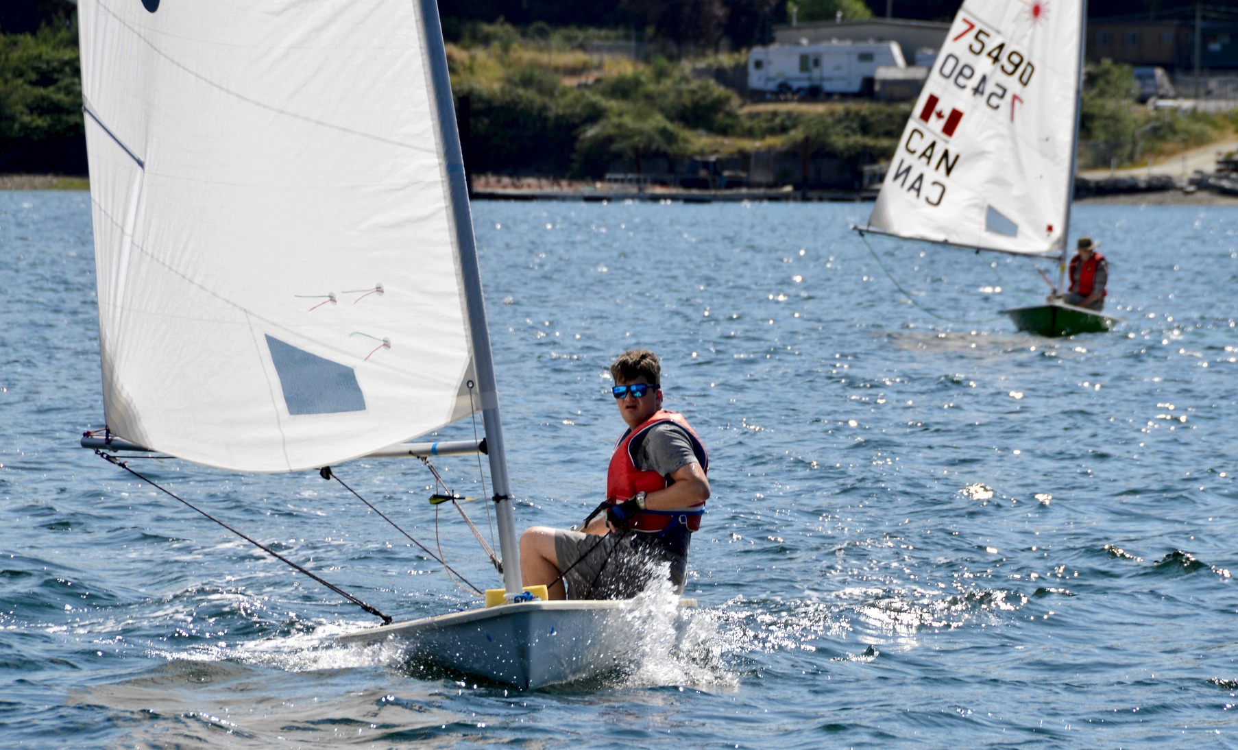 Robert Dall and Errol sailing his laser on the 6th Annual Poise Cove Regatta July 16th, 2017